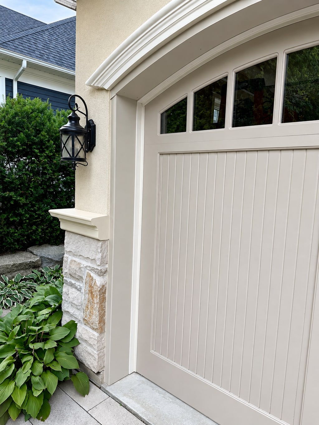 Close view of a painted carriage-style garage door and surrounding trim